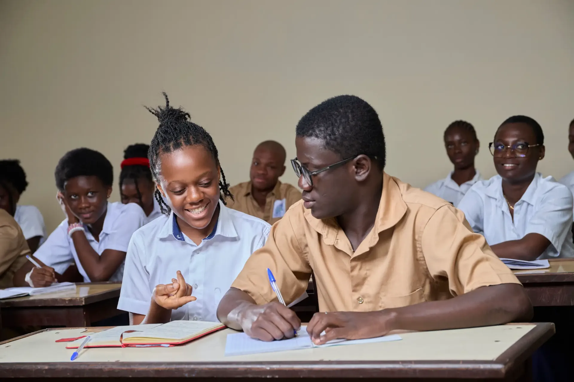 Two students working through an exercise together at a shared desk